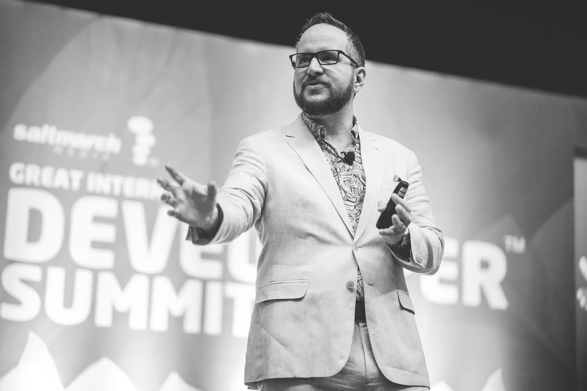 Michael Carducci on stage, one hand reaching out toward the audience